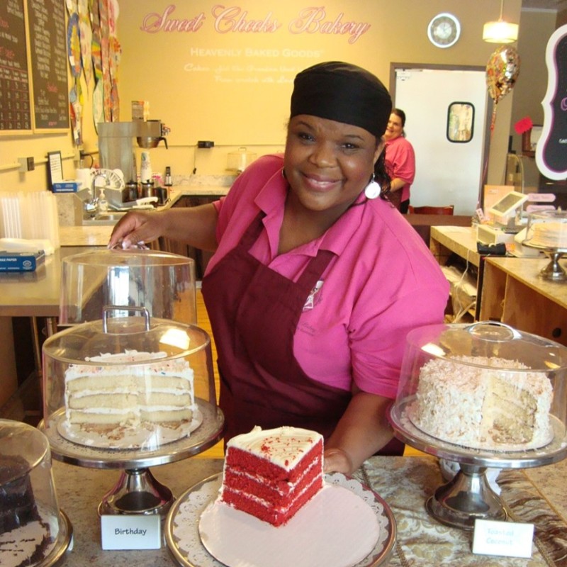 Owner Jackie Green of Sweet Cheeks Bakery shows three of her cakes.